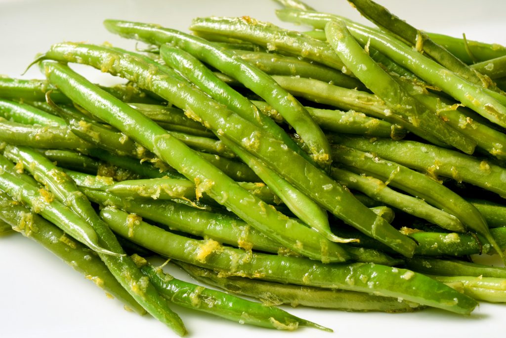 pile of sautéed green beans with lemon zest