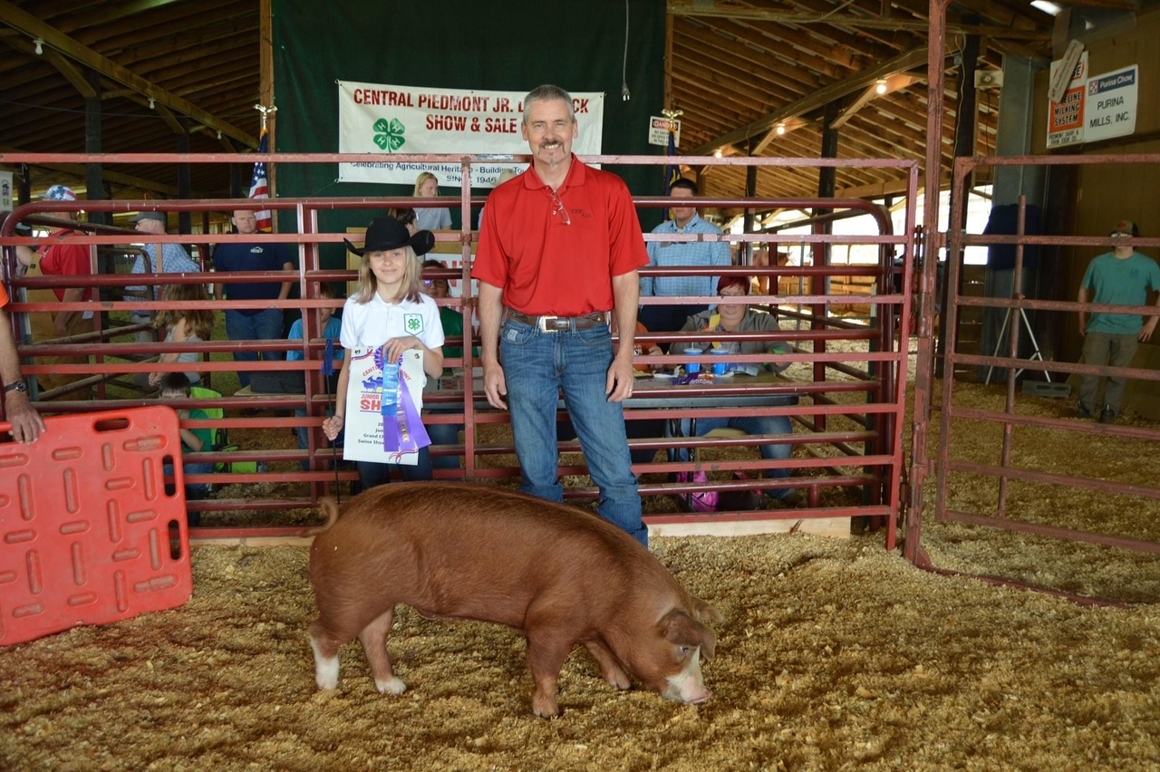 Girl showing pig