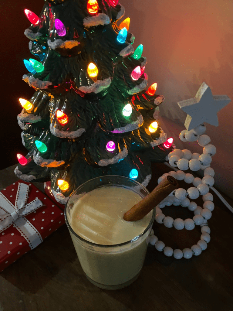 Decorative Christmas trees with mug of egg nog