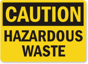 The words CAUTION HAZARDOUS WASTE on yellow and black background