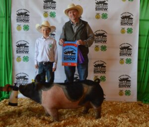 Boy showing pig